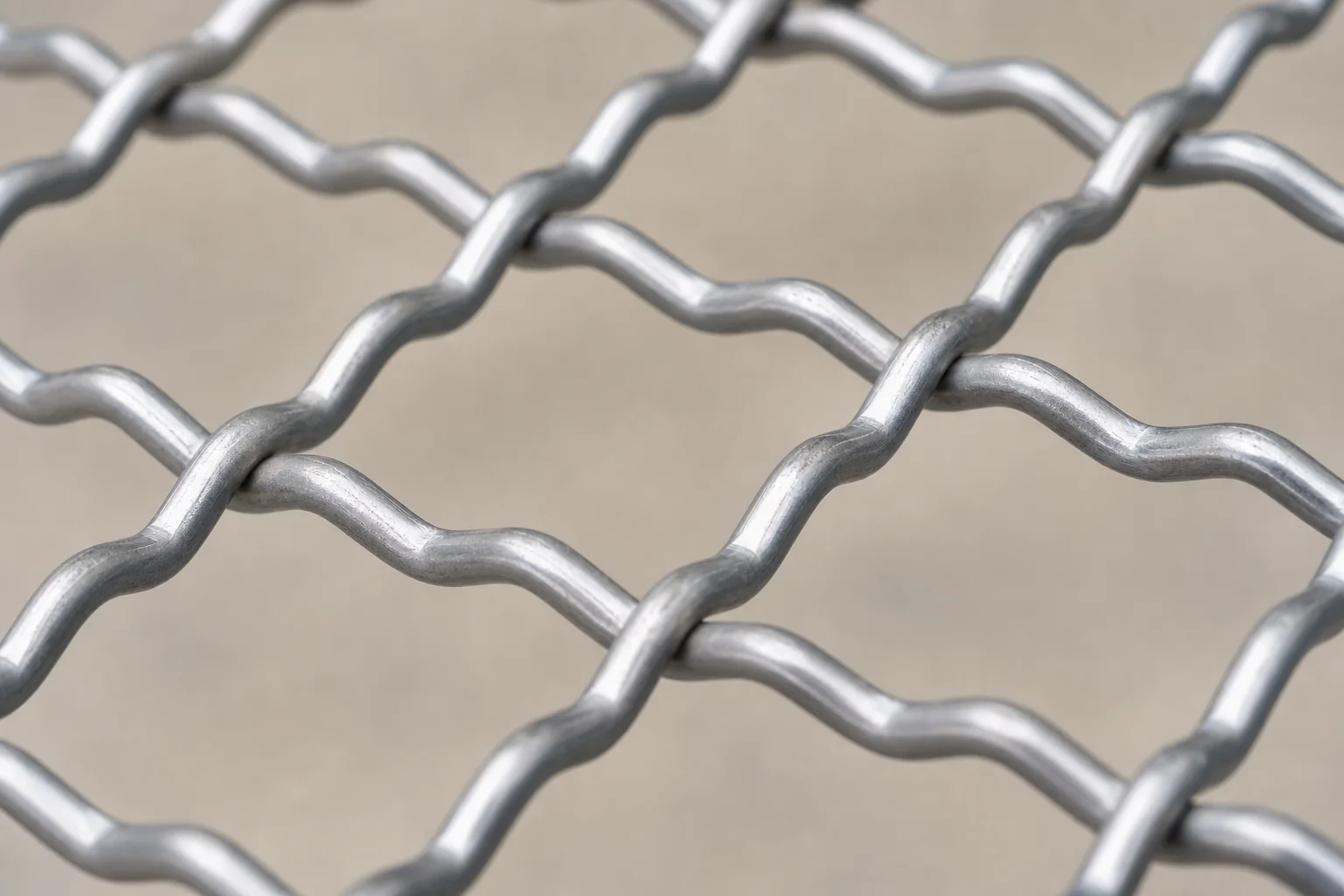 Close macro view of pre-crimped steel wire intersections