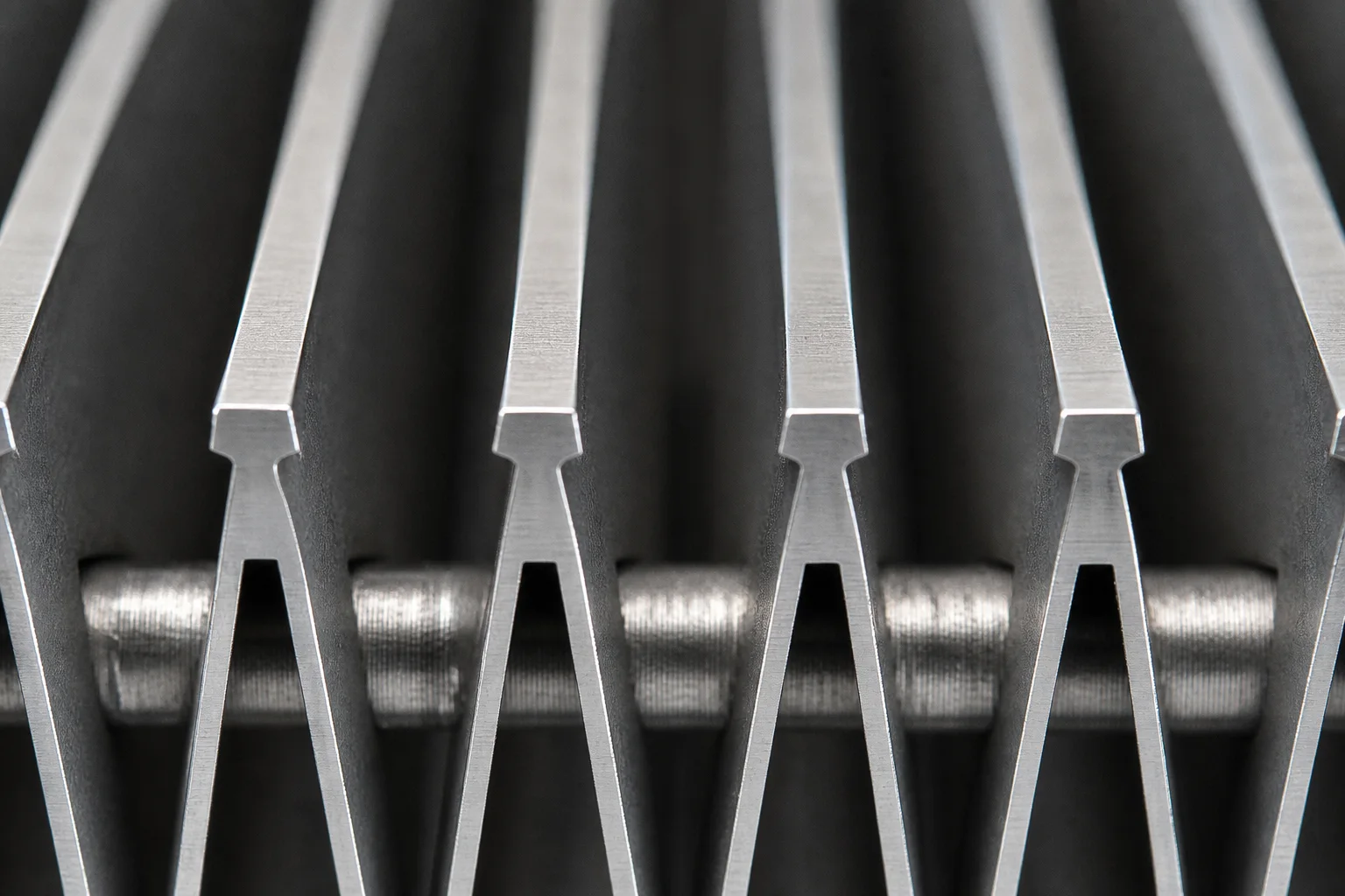Macro view of stainless V-profile wires and inward-opening slots