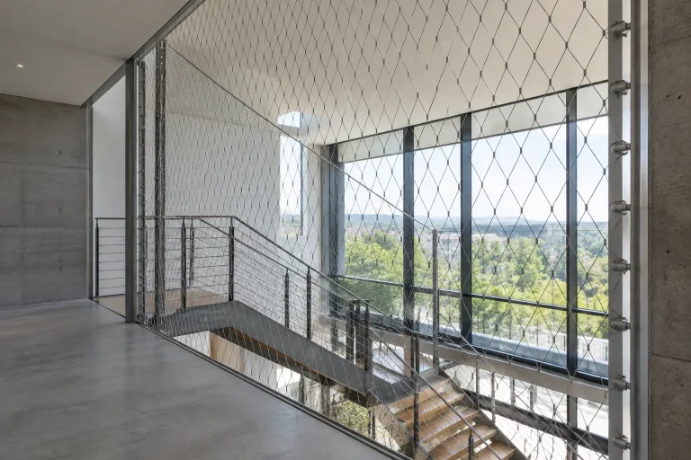 Diamond stainless steel wire rope mesh spanning a building stairwell